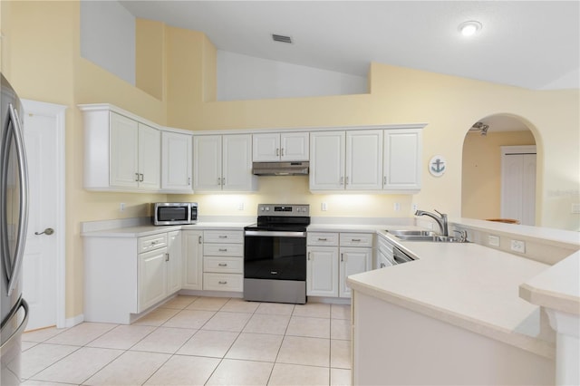 kitchen featuring light tile patterned floors, kitchen peninsula, appliances with stainless steel finishes, and white cabinets