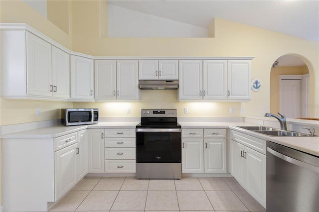 kitchen with sink, white cabinetry, appliances with stainless steel finishes, high vaulted ceiling, and light tile patterned floors