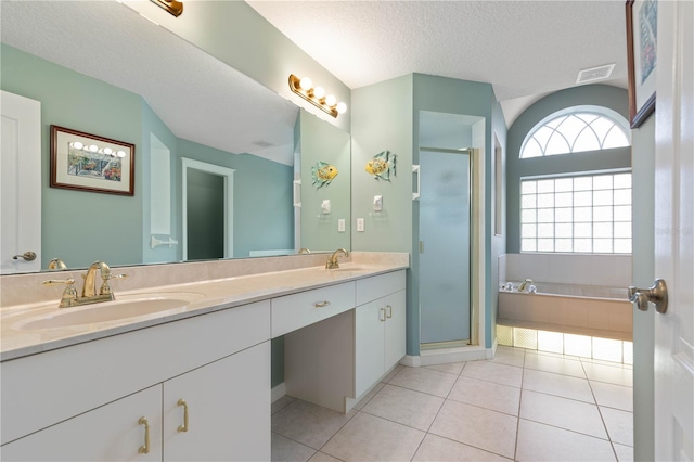 bathroom featuring plenty of natural light, a textured ceiling, tile patterned floors, and plus walk in shower