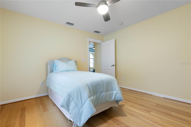 bedroom with ceiling fan and wood-type flooring