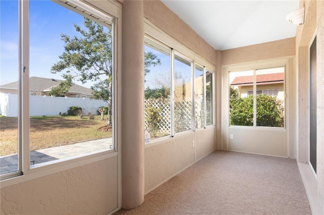 unfurnished sunroom featuring lofted ceiling