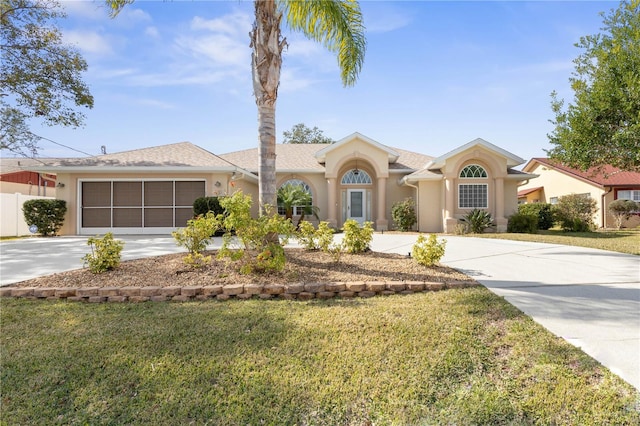 ranch-style home with a garage and a front lawn