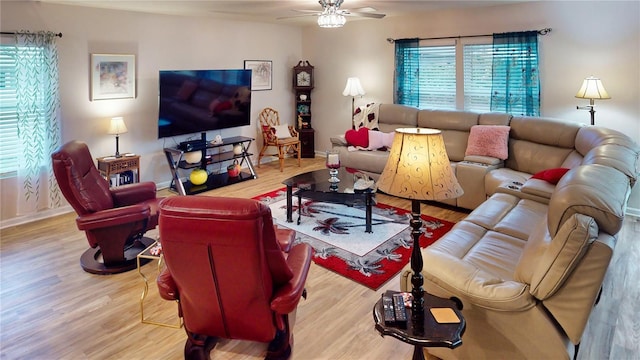 living room with ceiling fan and light hardwood / wood-style flooring