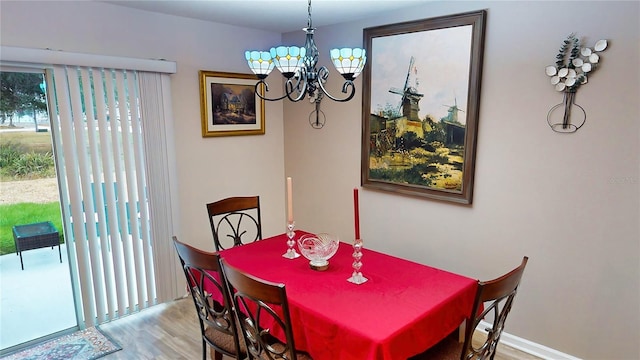 dining area with an inviting chandelier and hardwood / wood-style flooring