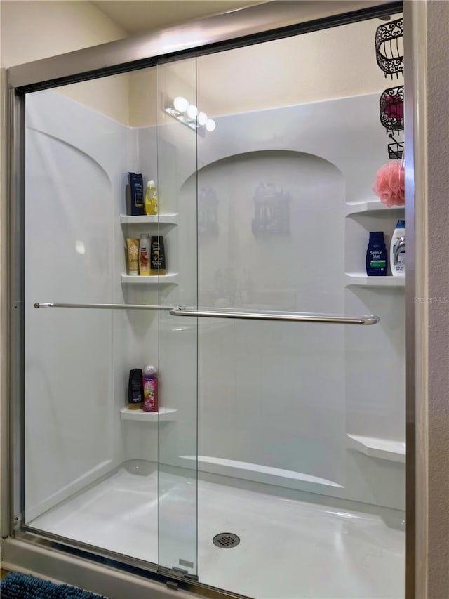 bathroom with a shower with shower door