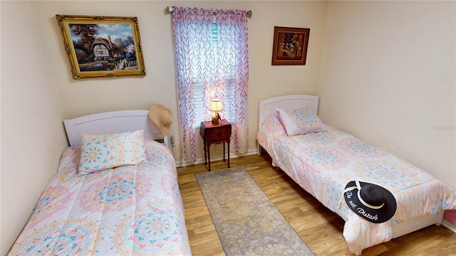 bedroom with wood-type flooring