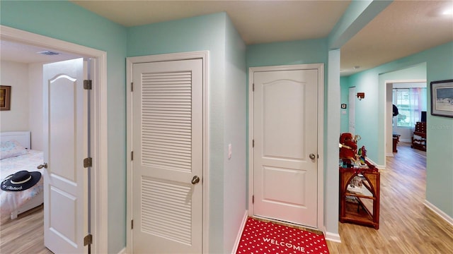 corridor featuring light hardwood / wood-style floors