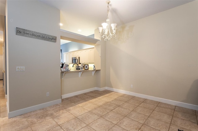 unfurnished dining area with sink, light tile patterned floors, and an inviting chandelier