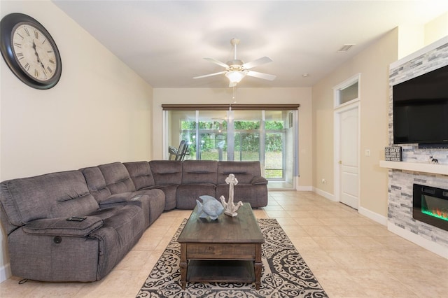 living room with ceiling fan, light tile patterned floors, and a fireplace