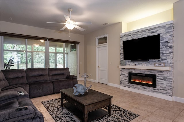 living room with ceiling fan, light tile patterned flooring, and a fireplace