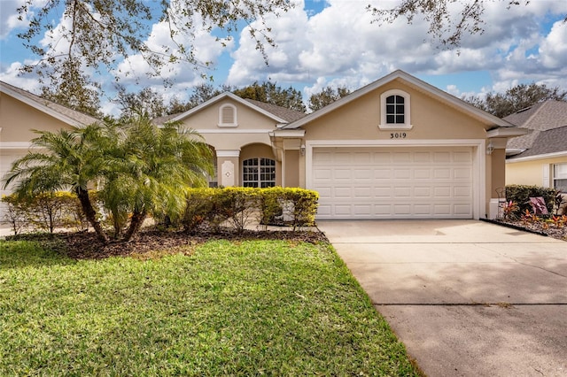 single story home featuring a garage and a front yard