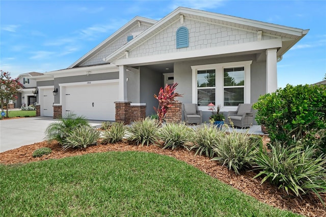 craftsman-style house featuring a garage and a front yard