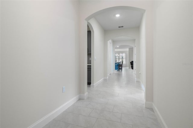 hallway featuring light tile patterned flooring