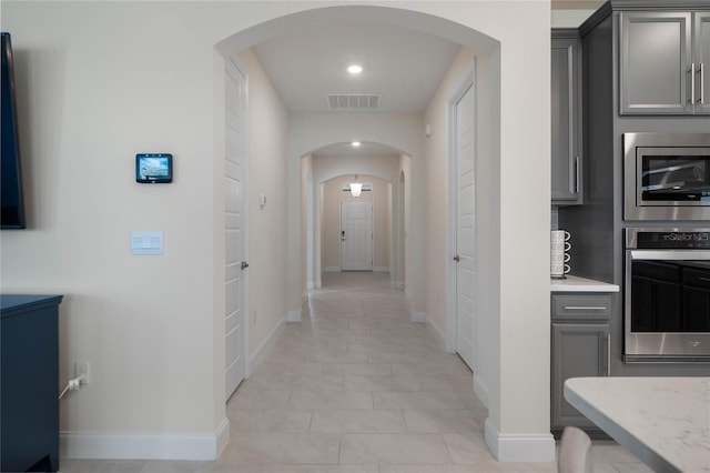 hallway with light tile patterned flooring