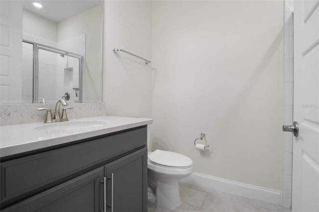 bathroom featuring toilet, tile patterned floors, an enclosed shower, and vanity