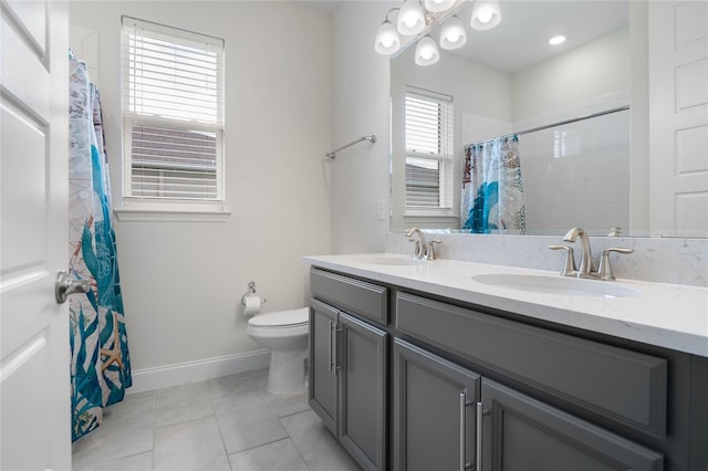 bathroom featuring toilet, vanity, and tile patterned flooring