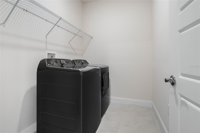 laundry area featuring tile patterned floors and independent washer and dryer