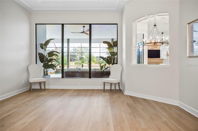 spare room featuring wood-type flooring and an inviting chandelier