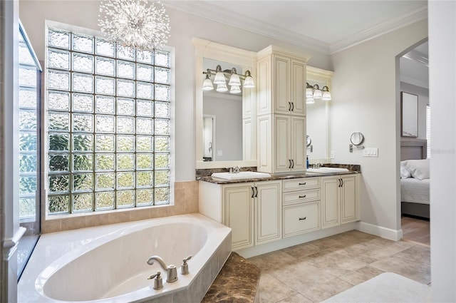 bathroom with tiled bath, an inviting chandelier, tile patterned floors, crown molding, and vanity