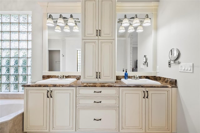 bathroom featuring vanity, a wealth of natural light, and ornamental molding