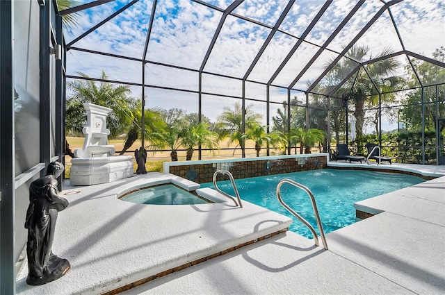 view of pool with a lanai, pool water feature, a patio area, and an in ground hot tub