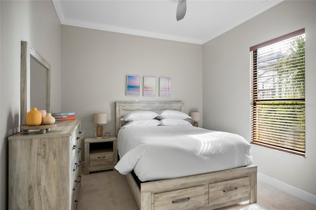 carpeted bedroom featuring ceiling fan and ornamental molding