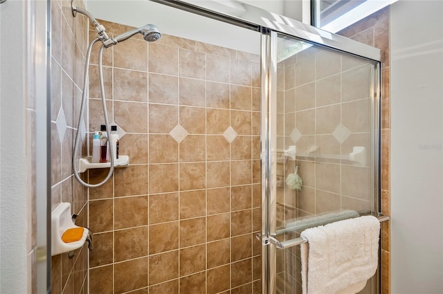 bathroom featuring a shower with door