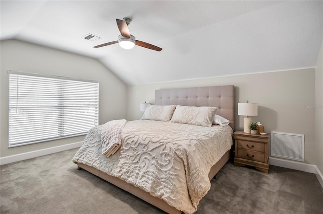 bedroom with ceiling fan, lofted ceiling, and dark colored carpet