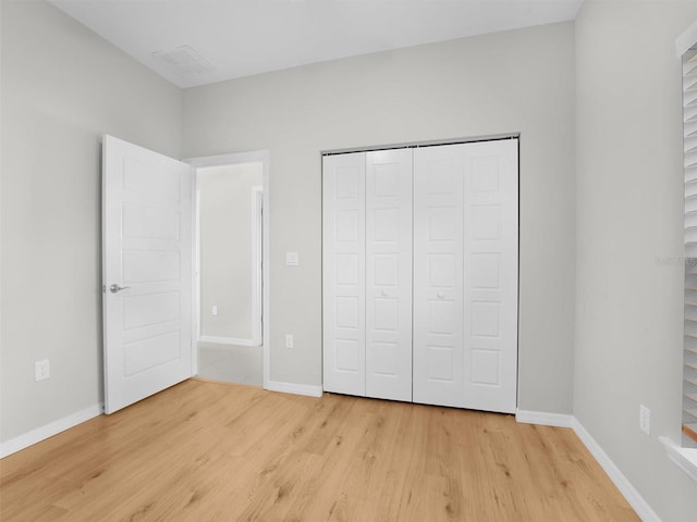 unfurnished bedroom featuring a closet and light hardwood / wood-style flooring