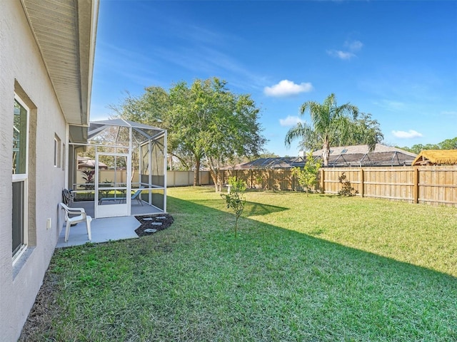 view of yard featuring a lanai and a patio