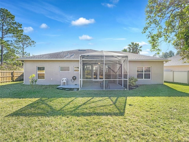 back of house with a patio, a lanai, and a yard