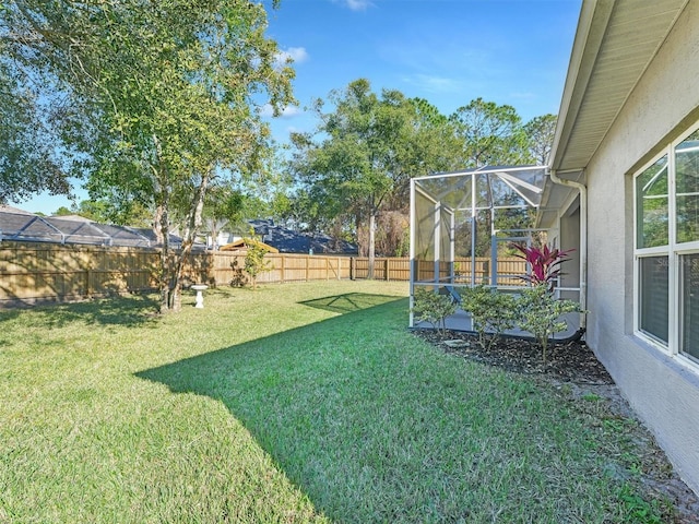 view of yard featuring glass enclosure