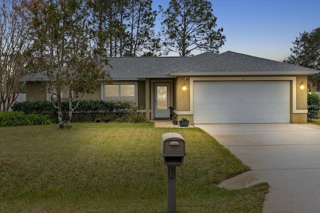 ranch-style home with a garage and a front lawn