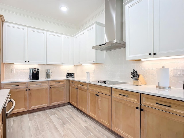 kitchen featuring decorative backsplash, wall chimney exhaust hood, black electric stovetop, and light hardwood / wood-style flooring