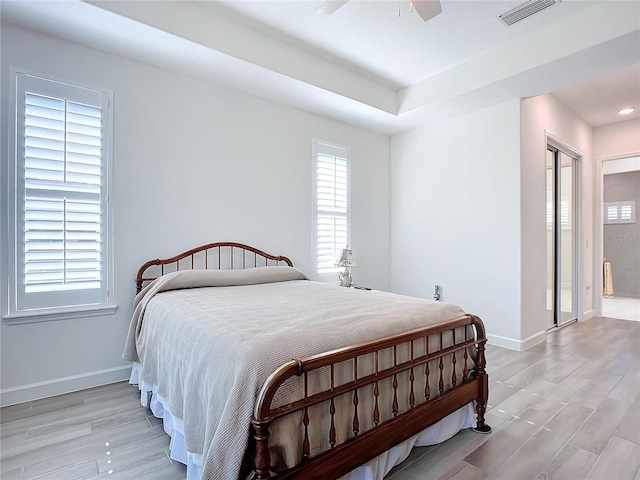 bedroom with ceiling fan, a closet, and light hardwood / wood-style floors