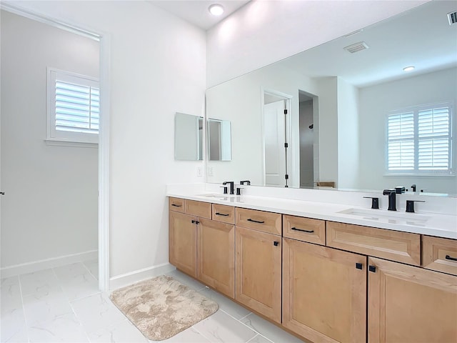 bathroom with plenty of natural light and vanity