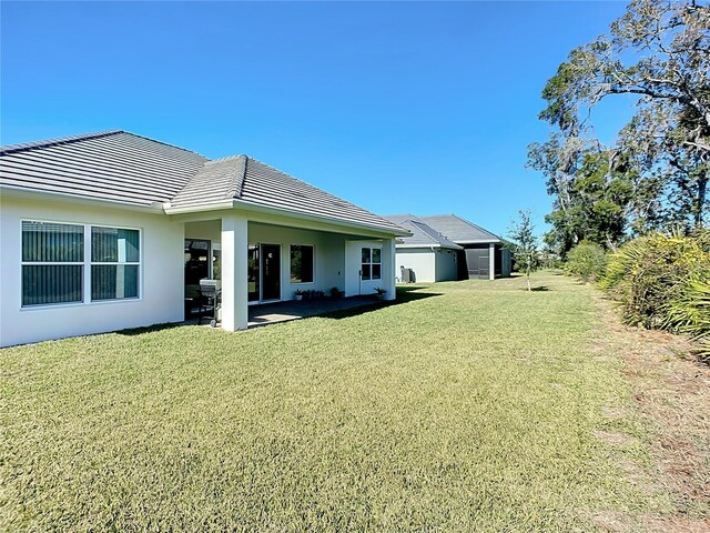 rear view of house featuring a yard