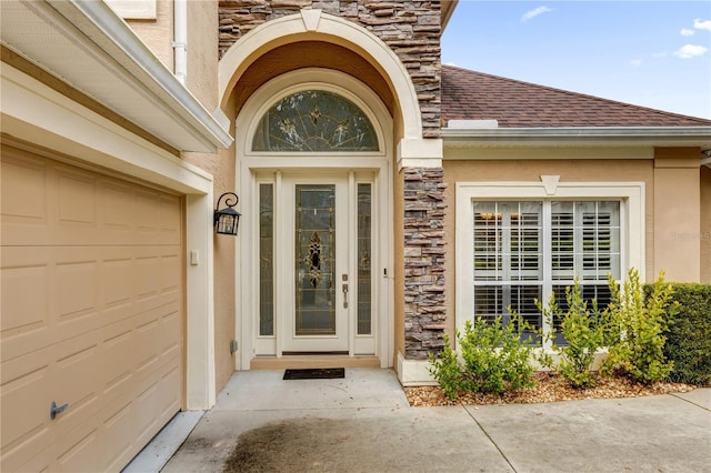 view of exterior entry with a garage