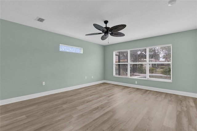 empty room with light hardwood / wood-style floors and ceiling fan