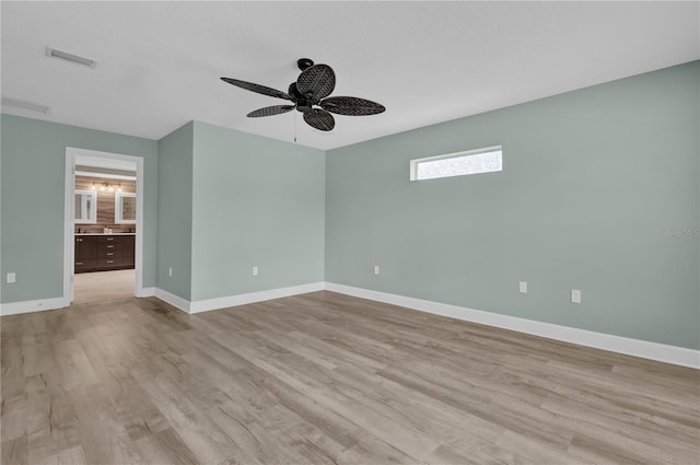 unfurnished room with ceiling fan and light hardwood / wood-style floors