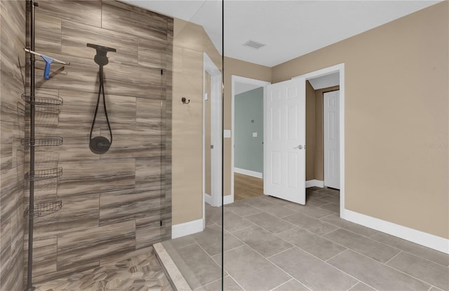 bathroom featuring a tile shower and tile patterned floors