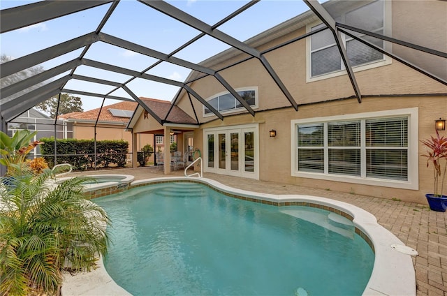 view of swimming pool featuring a lanai, a patio area, and an in ground hot tub