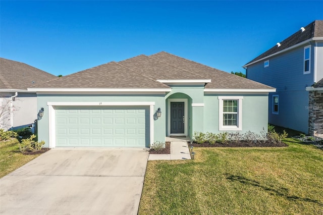 view of front of property with a front yard and a garage