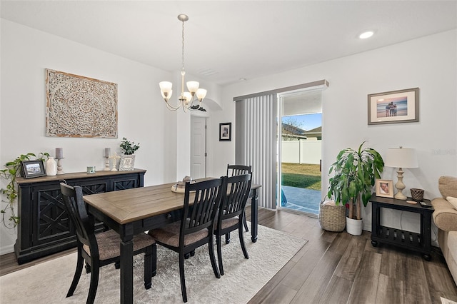 dining room with hardwood / wood-style flooring and a chandelier