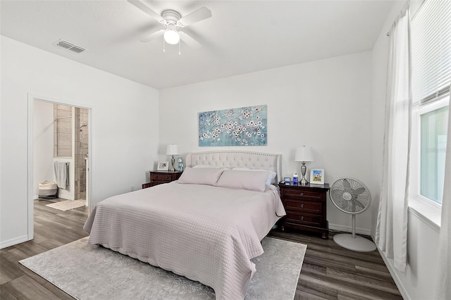 bedroom featuring ceiling fan, dark hardwood / wood-style flooring, and connected bathroom