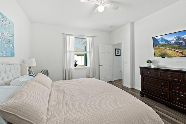 bedroom with ceiling fan and dark hardwood / wood-style flooring