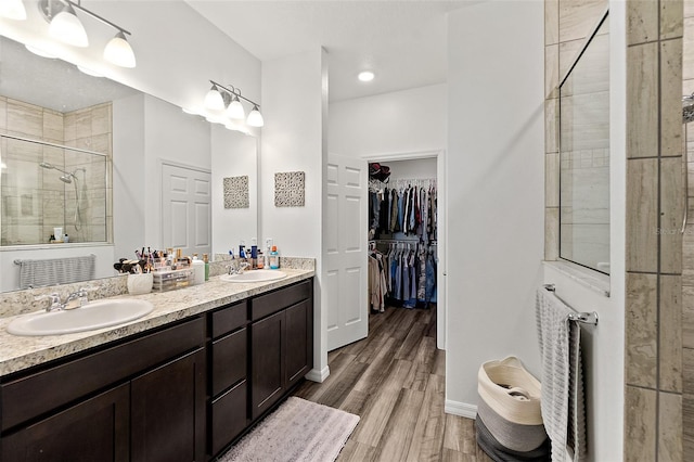 bathroom with vanity, wood-type flooring, and walk in shower