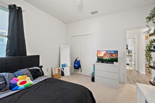 carpeted bedroom featuring a closet and ceiling fan