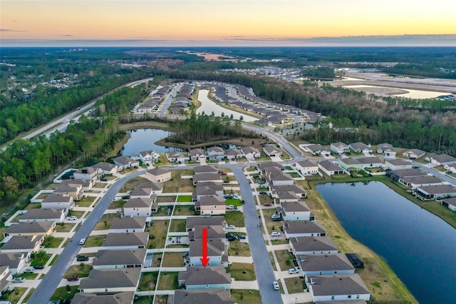 aerial view at dusk with a water view