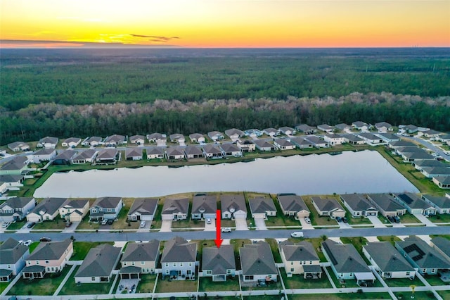 aerial view at dusk with a water view